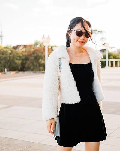 white faux fur crochet coat with collar and blue handbag
