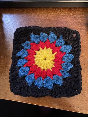 Sunburst granny square from WIP jacket -- archery themed!